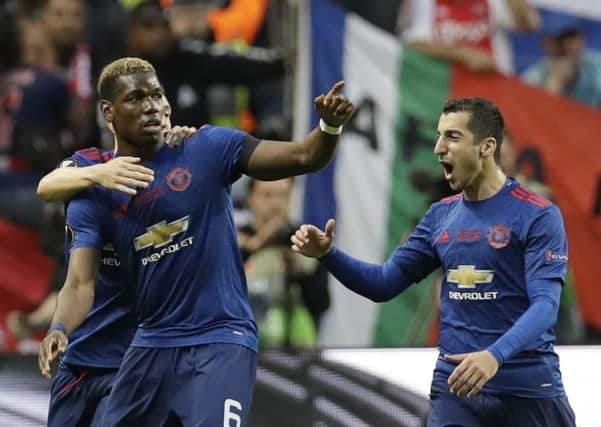 Man United's Paul Pogba celebrates with team-mates Matteo Darmian and Henrikh Mkhitaryan, right, after opening the scoring in the Europa League final. Picture Michael Sohn/AP