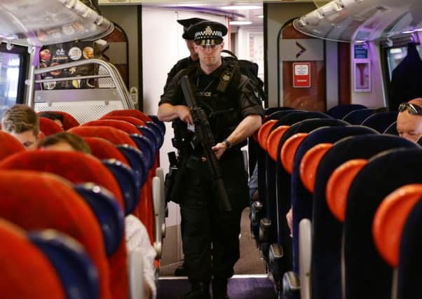 Armed British Transport Police Specialist Operations officers on board a Virgin train to Birmingham New Street. Picture: PA