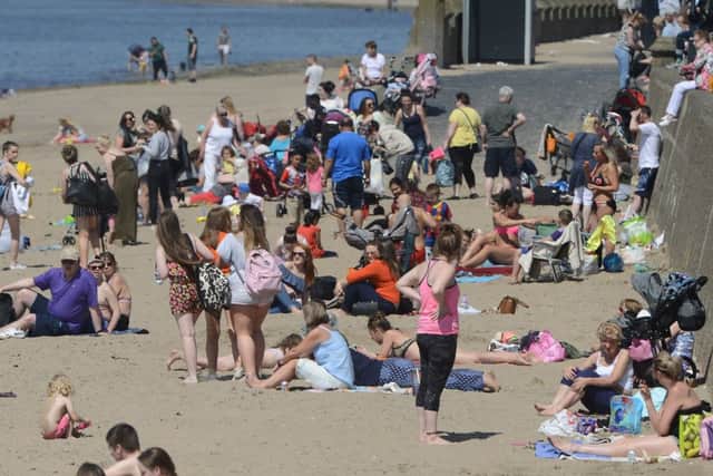 People on Ayr beach enjoy some hot weather as temperatures hit 27c in parts of Scotland. Picture: SWNS