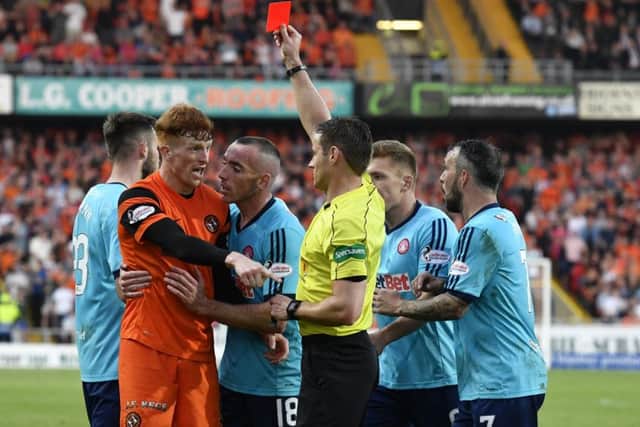 A furious Simon Murray is restrained by Hamiltons Darian McKinnon as he tries to tell red-card wielding referee Steven McLean that he had been fouled and not dived. Picture: SNS