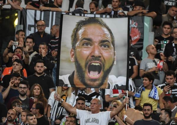 One Juventus fan, at least, is convinced of the merits of Gonzalo Higuain who has a chance on Saturday to give la Vecchia Signora their third title. Photograph: AFP/Getty