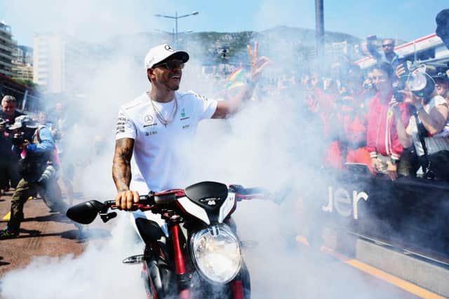 Lewis Hamilton does a burnout on his motorbike for fans during practice for the Monaco Grand Prix. Picture: Shaun Botterill/Getty Images