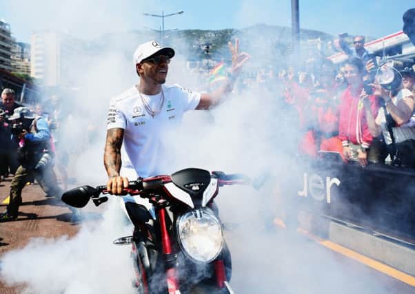 Lewis Hamilton does a burnout on his motorbike for fans during practice for the Monaco Grand Prix. Picture: Shaun Botterill/Getty Images