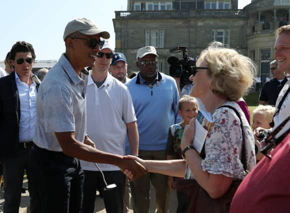 Former US president Barack Obama meets well-wishers as he plays a round of golf at St Andrews. Pic: Andrew Milligan/PA Wire