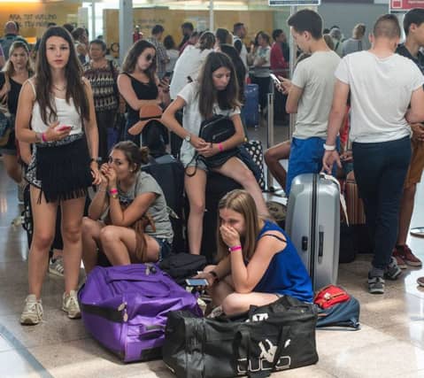Passengers queue in front of Spanish low-cost airline Vueling check-in counters at the El Prat Airport in Barcelona on July 5, 2016.
Hundreds of passengers were left stranded today following the sixth straight day of cancellations and major delays involving flights by Spanish budget airline Vueling.
/ AFP / JOSEP LAGO (Photo credit should read JOSEP LAGO/AFP/Getty Images)