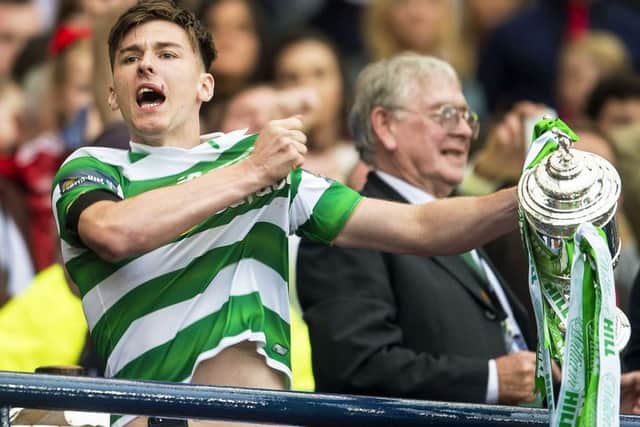 Kieran Tierney lifts the Scottish Cup after leaving the game early due to injury. Pic: SNS/Bill Murray