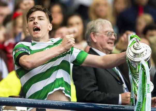 Kieran Tierney lifts the Scottish Cup after leaving the game early due to injury. Pic: SNS/Bill Murray
