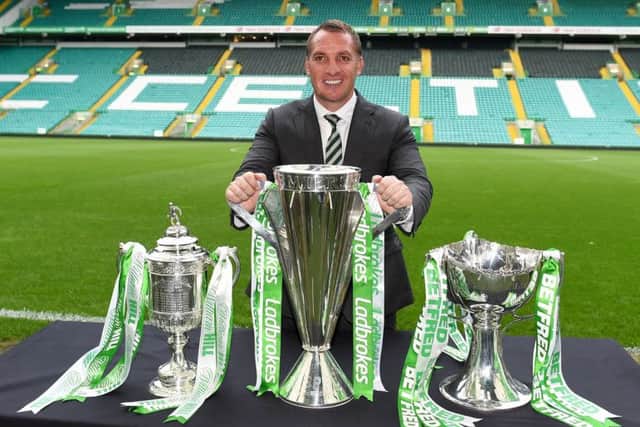 Brendan Rodgers poses with the William Hill Scottish Cup, Ladbrokes Premiership and Betfred Cup in Celtic Park. Pic: SNS/Paul Devlin