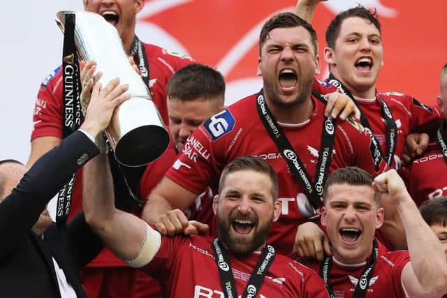 Scarlets' John Barclay lifts the trophy with his  team-mates. Picture: PA
