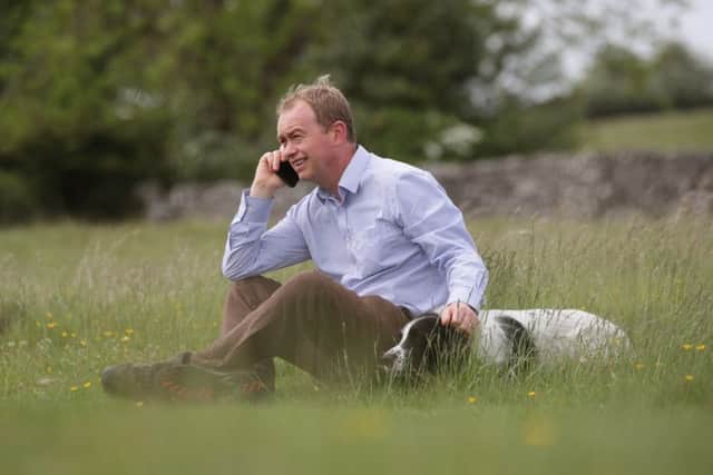 Tim Farron with his dog Jasper during a walkabout with the media in the Lake District. Picture: PA