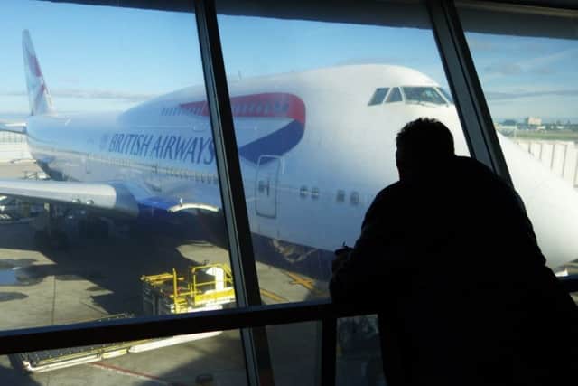 A passenger looks at a British Airways aircraft at JFK Airport in New York as an IT failure grounded flights. Picture: AFP/Getty Images