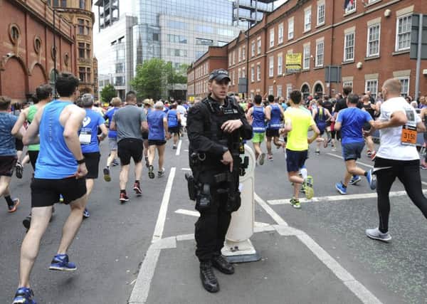 Armed response police stand at the start of the Great Manchester Run in central Manchester. (AP Photo/Rui Vieira)