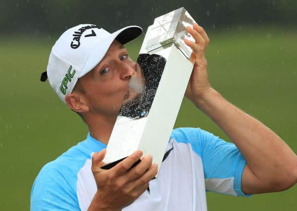 Alex Noren of Sweden kisses the trophy as he celebrates victory in the BMW PGA Championship at Wentworth. Picture: Getty Images
