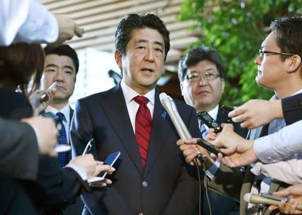 Japanese Prime Minister Shinzo Abe answers to a reporter's question about North Korea's missile launch, at his official residence in Tokyo this morning. (Muneyuki Tomari/Kyodo News via AP)