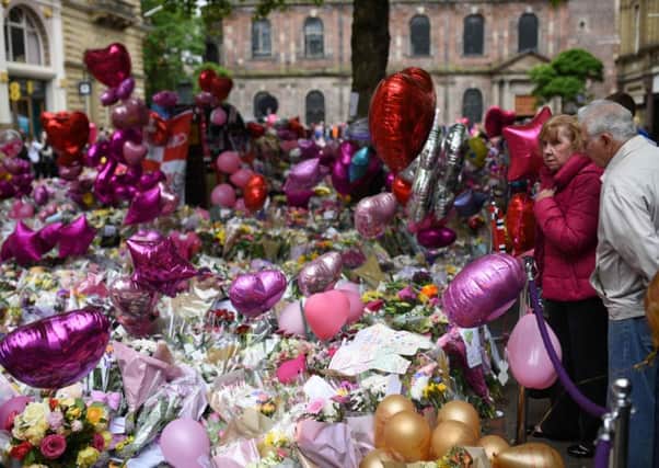 Floral tributes, pink balloons and messages of support are growing in St Anns Square in Manchester. Picture: AFP/Getty Images