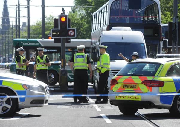 Traffic police at the scene where a cyclist was fatally injured after being hit by a minibus. Picture: Lisa Ferguson