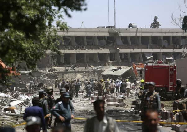 Security forces inspect near the site of an explosion where German Embassy is located in Kabul, Afghanistan, Wednesday, May 31, 2017. A massive explosion rocked a highly secure diplomatic area of Kabul on Wednesday morning, causing casualties and sending a huge plume of smoke over the Afghan capital. (AP Photos/Rahmat Gul)