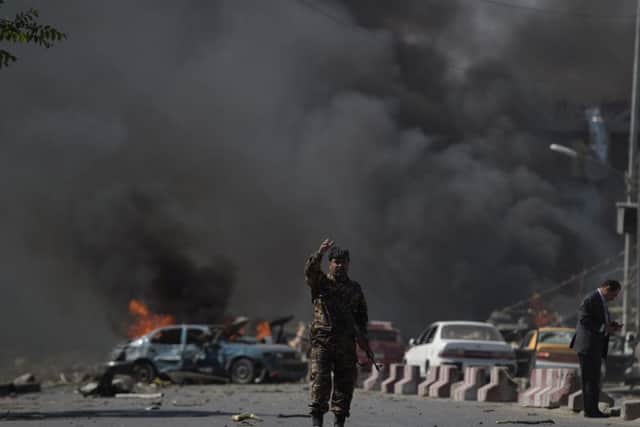 An Afghan security force member stands at the site of a car bomb attack in Kabul on May 31, 2017.
At least 40 people were killed or wounded on May 31 as a massive blast ripped through Kabul's diplomatic quarter, shattering the morning rush hour and bringing carnage to the streets of the Afghan capital. / AFP PHOTO / SHAH MARAISHAH MARAI/AFP/Getty Images