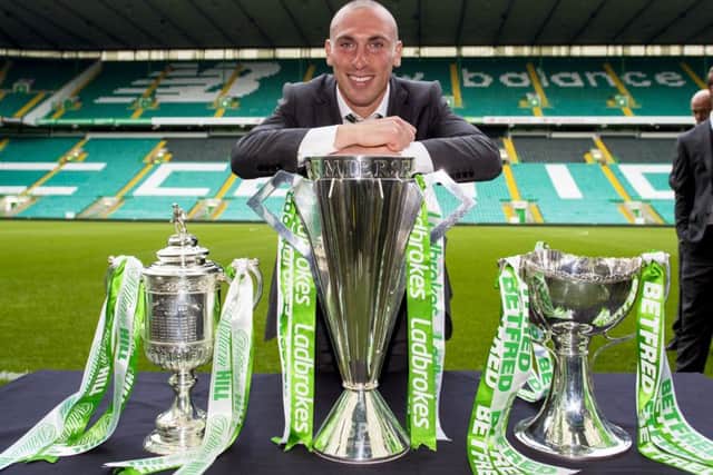 Celtic captain Scott Brown with the William Hill Scottish Cup, Ladbrokes Premiership and Betfred Cup. Picture: Paul Devlin/SNS