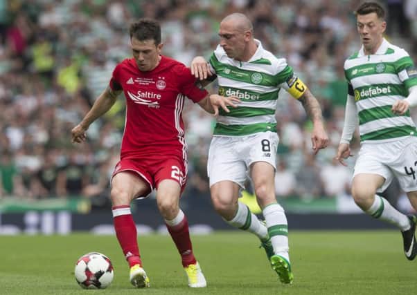 Ryan Jack, who produced an assured display for Aberdeen in Saturday's Scottish Cup final, shields the ball from Celtic's Scott Brown. Picture: SNS