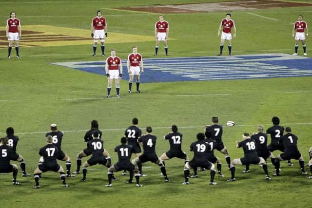 The 2005 British and Irish Lions captain Brian O'Driscoll, centre, stands with his team-mates as they watch the All Blacks perform a haka. Picture: Mark Baker/AP
