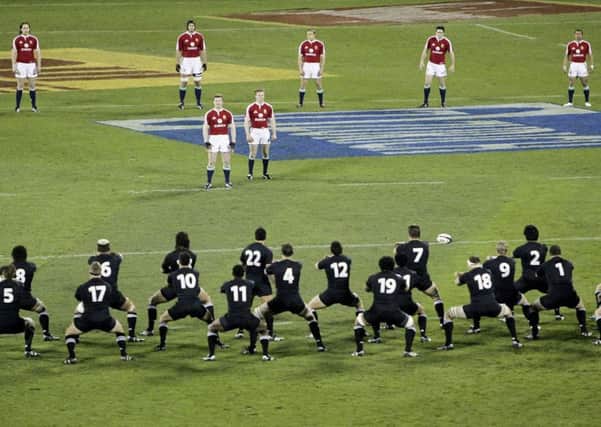 The 2005 British and Irish Lions captain Brian O'Driscoll, centre, stands with his team-mates as they watch the All Blacks perform a haka. Picture: Mark Baker/AP