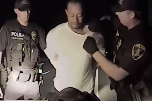 This still image from a dashcam video released by the Jupiter, Florida, Police Department shows offices arresting Tiger Woods on May 29. Picture: AFP PHOTO / Jupiter Police Department