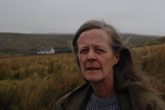 Author Sara Maitland with her isolated cottage in moorland in Galloway in the background. PIC:  Robert Perry/ Scotland on Sunday.