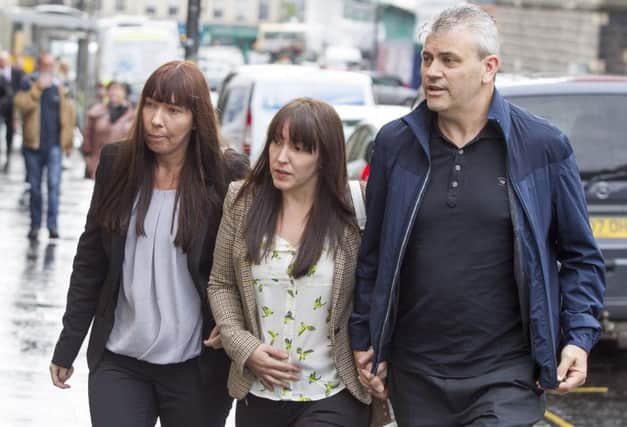 Abbie Wallis(centre) the mother of Keane Wallis-Bennett arrives with her partner James Glendinning at Edinburgh Sheriff Court for the FAI into death of her daughter when a wall collapsed on her at Liberton High School, Edinburgh in April 2014.