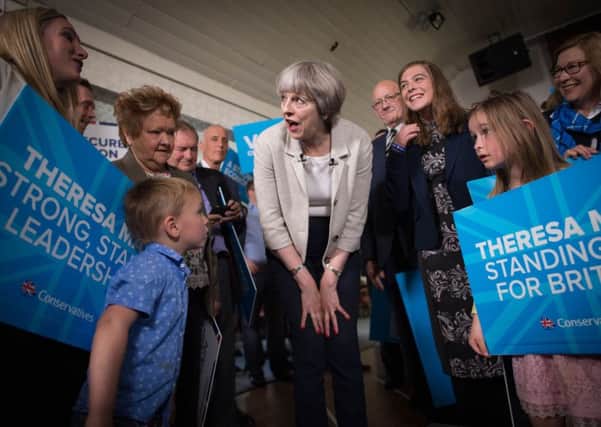 Theresa May speaks to supporters and their children yesterday in Dewsbury, West Yorkshire. Picture: Stefan Rousseau/PA