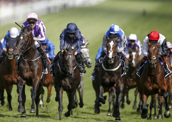 Padraig Beggy, riding Wings Of Eagles (second left, pink cap), wins The Investec Derby from Cliffs Of Moher (centre, dark blue). Picture: Alan Crowhurst/Getty Images