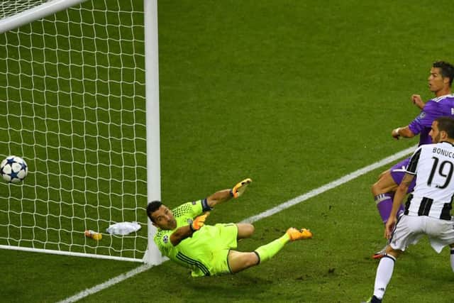 Cristiano Ronaldo flicks the ball over Gianluigi Buffon to effectively end the contest in Cardiff.
Picture: Getty Images