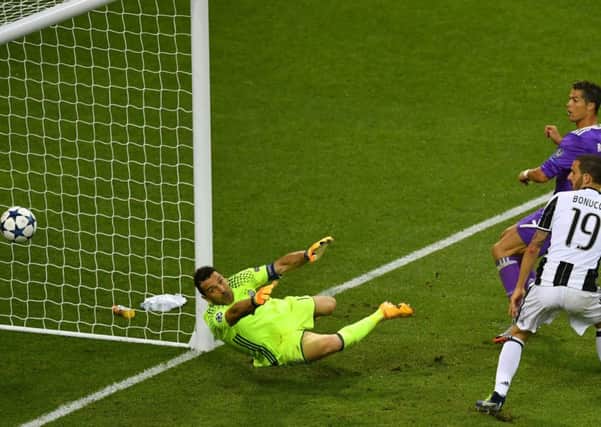 Cristiano Ronaldo flicks the ball over Gianluigi Buffon to effectively end the contest in Cardiff. 
Picture: Getty Images