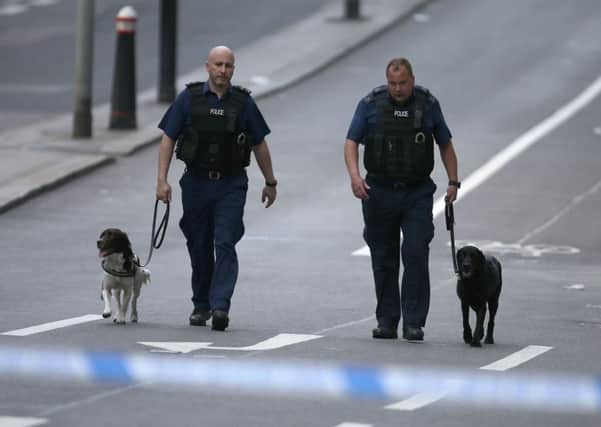 Members of the Police with sniffer dogs work on London Bridge. Picture: AFP/Getty