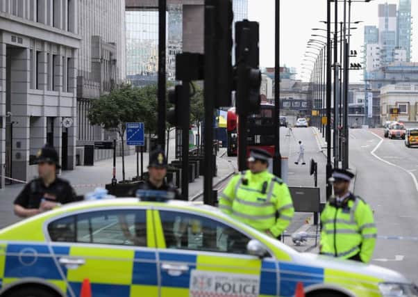 Police operate a cordon on the north side of London Bridge as forensic officers work. Picture: Getty
