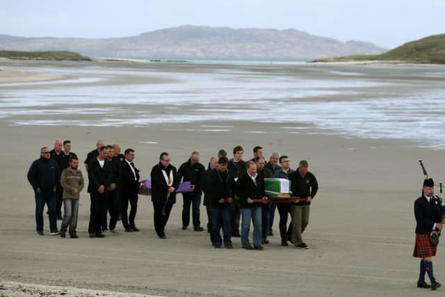 The coffin of Eilidh MacLeod draped in the Barra flag is carried across Traigh Mhor beach at Barra airport after it arrived by chartered plane. Picture: Andrew Milligan/PA Wire