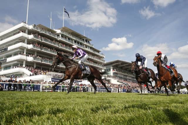 Wings Of Eagles, left, wins The Investec Derby from Cliffs Of Moher, centre, at Epsom. Picture Alan Crowhurst/Getty Images