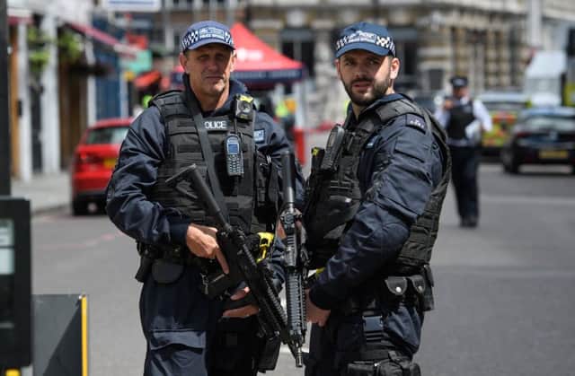 LONDON, ENGLAND - JUNE 04:  Armed police officers stand guard at the perimeter cordon, following Saturday's London terror attack. Picture: Leon Neal/Getty Images