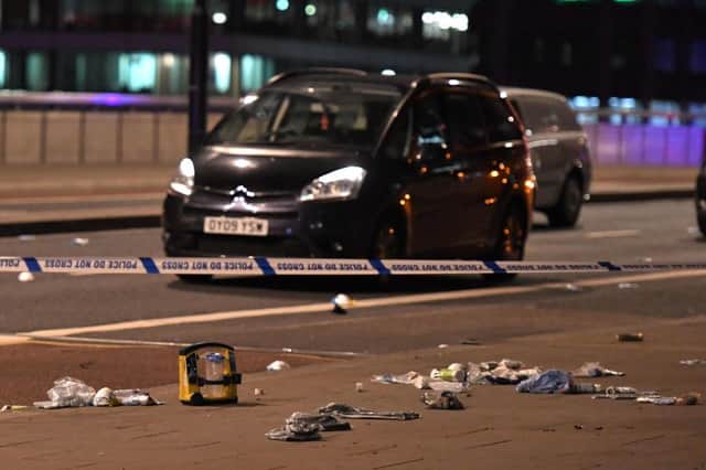 Debris and abandoned cars remain on London Bridge at the scene of the terror attack in central London. Picture: CHRIS J RATCLIFFE/AFP/Getty Images