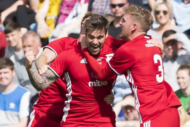 Glenaftons Cammy Marlow celebrates after scoring the equaliser in the first half yesterday.