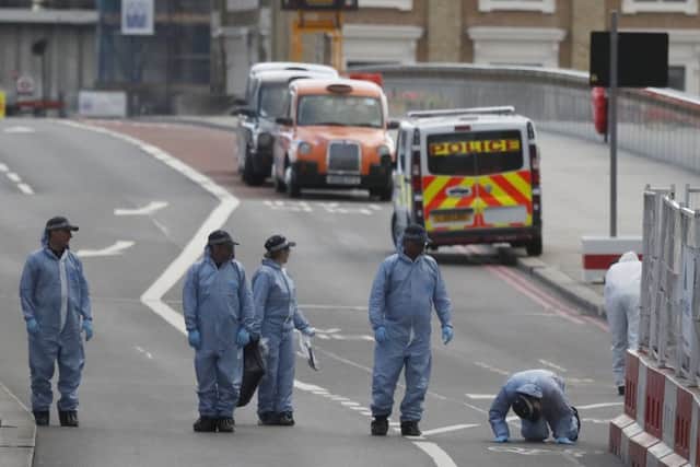 Forensic police collect evidence in the London Bridge area.
