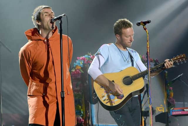 Liam Gallagher (L) and Chris Martin of Coldplay perform on stage during the One Love Manchester Benefit Concert. (Photo by Kevin Mazur/Getty Images)