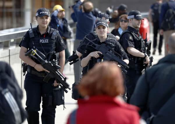 Armed  police officers patrol at London Bridge, scene of Saturday night's terrorist attack. Picture: AFP