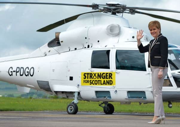 First Minister Nicola Sturgeon walks to her helicopter during the election campaign. Picture: Mark Runnacles/PA Wire