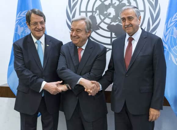 U.N. Secretary-General Antonio Guterres, center, shakes hands with Cypriot President Nicos Anastasiades, left, and Turkish Cypriot leader Mustafa Akinci, right, at the United Nations headquarters. Picture: AP Photo/Craig Ruttle