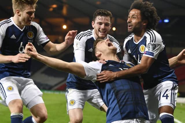 Chris Martin celebrates his late goal with his Scotland team-mates in the 1-0 win over Slovenia at Hampden in March.