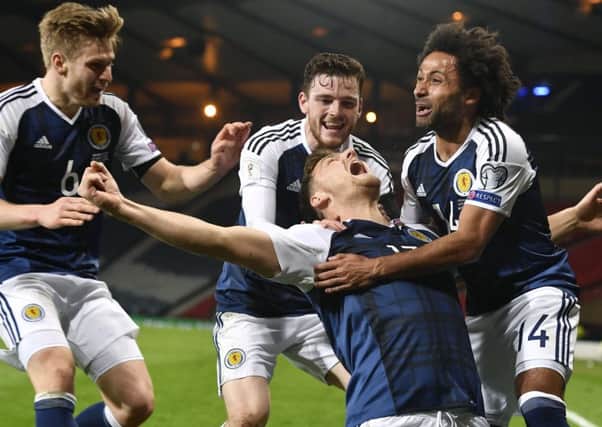 Chris Martin celebrates his late goal with his Scotland team-mates in the 1-0 win over Slovenia at Hampden in March.