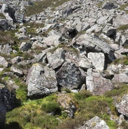 The cliff face behind the site, which the assoication believes could have concealed smoke from fires lit at the 'cage'. PIC: Contributed.