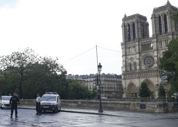 Police officers seal off the access to Notre Dame cathedral in Paris. Picture: AP