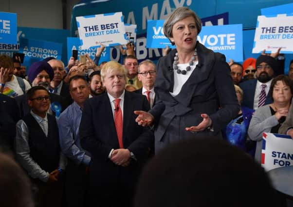 Theresa May is accompanied by Foreign Secretary Boris Johnson as she addresses supporters at the campaign event in Slough. Pic: Getty